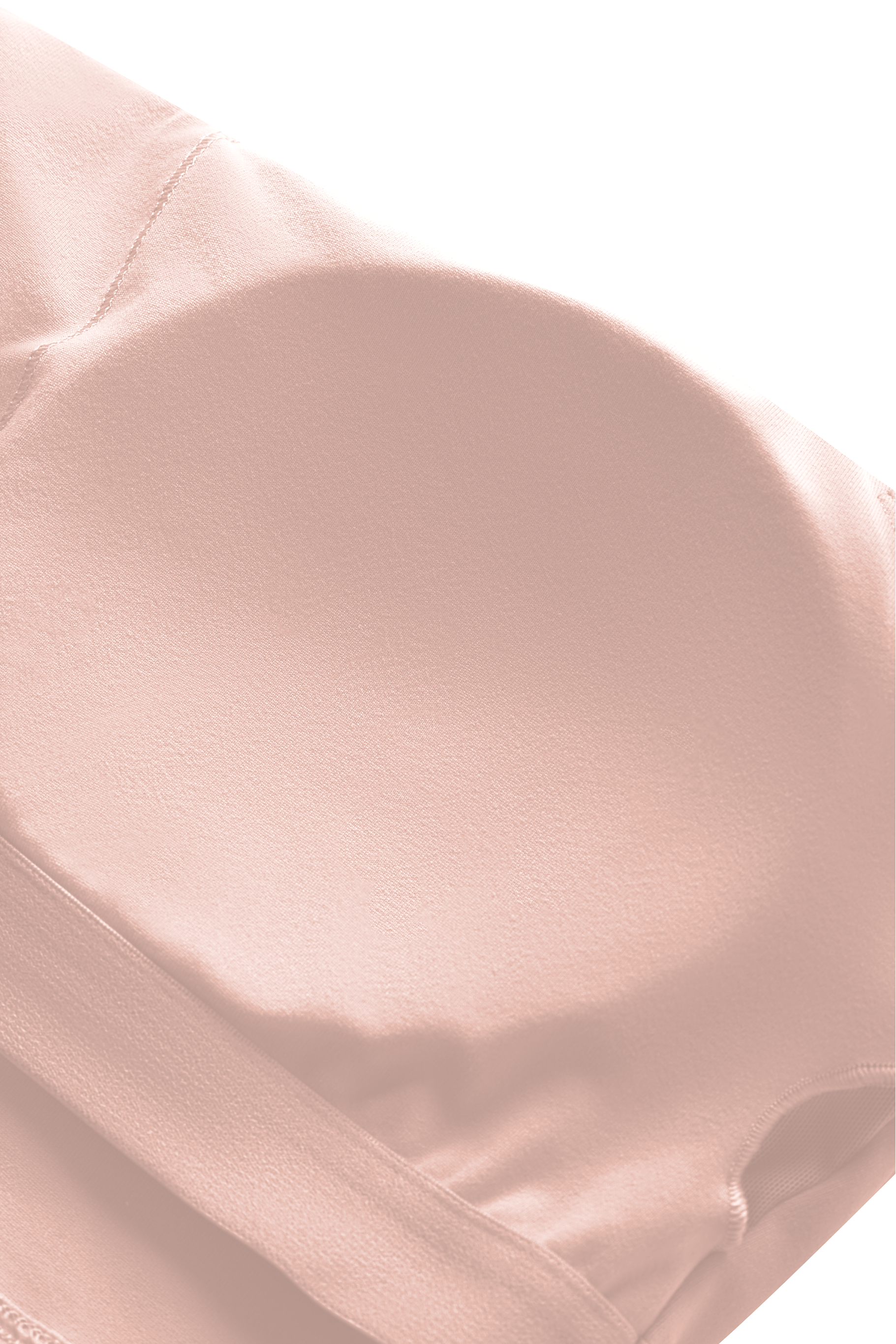 Close-up of a pink bra cup padding with a soft texture on a white background