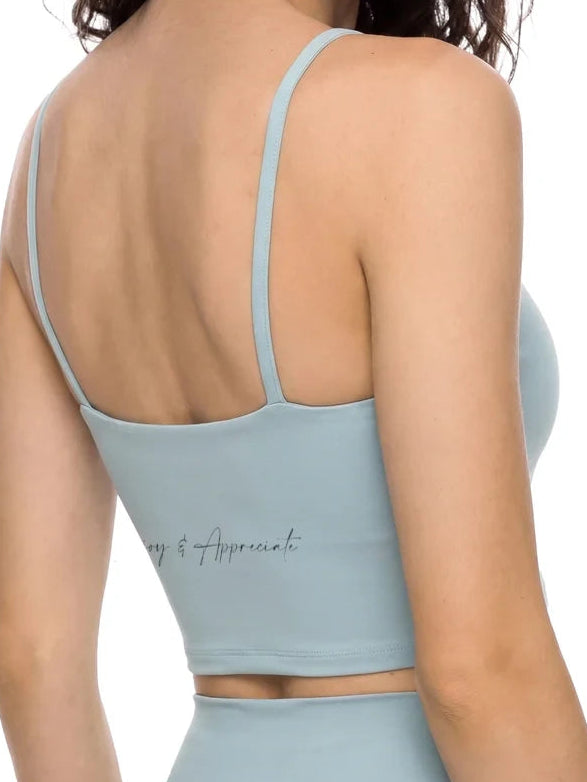Light blue sports bra and leggings set on a white background