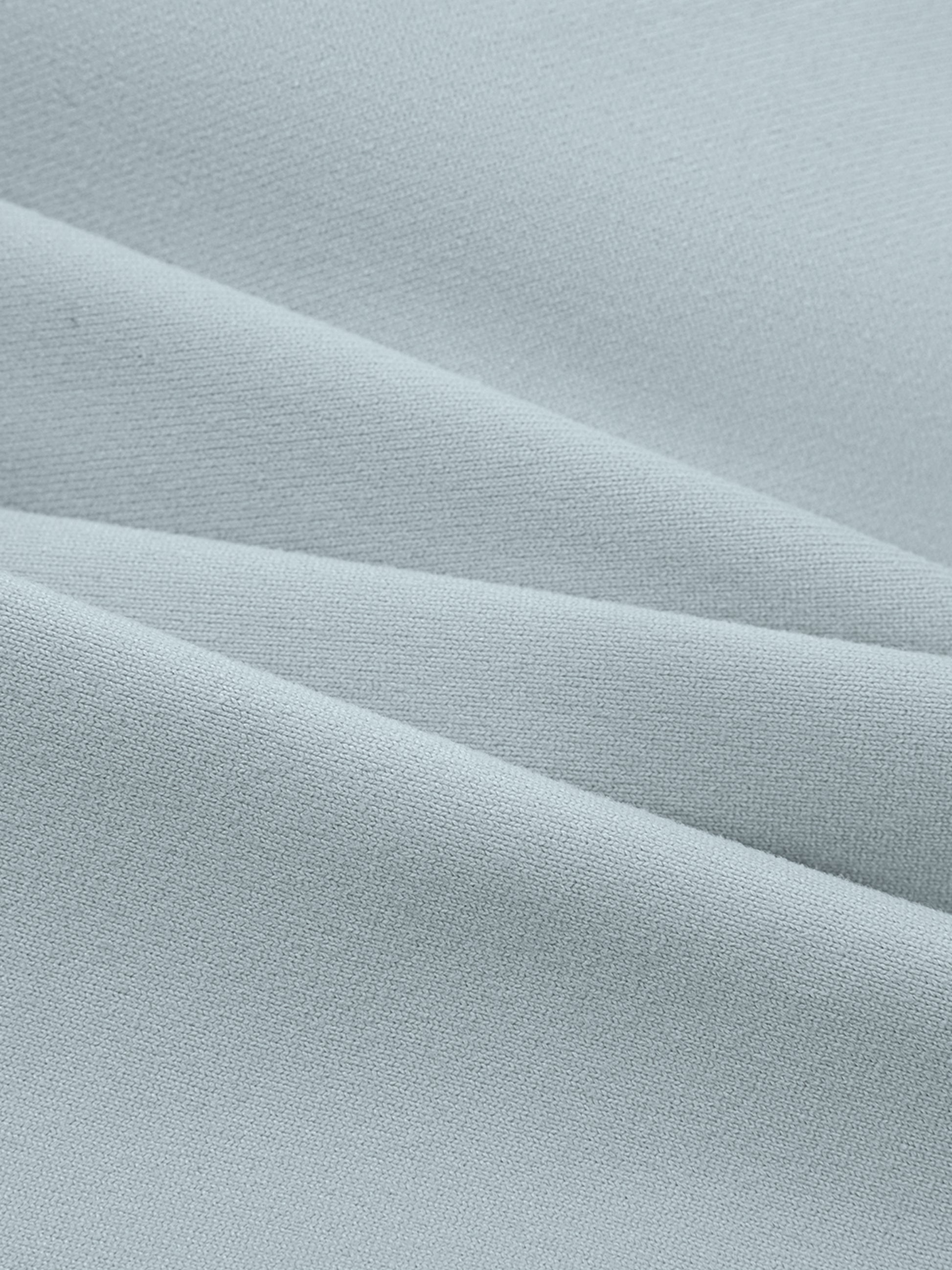 Close-up of light blue fabric with subtle texture