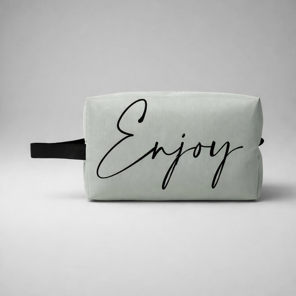 Sports toilet bag mini in light mint green with black handle and enjoy printed in elegant black cursive script