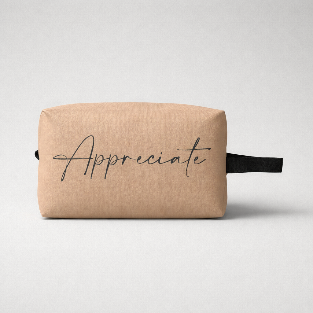 Beige canvas sports toilet bag mini with black cursive appreciate print and matching black strap