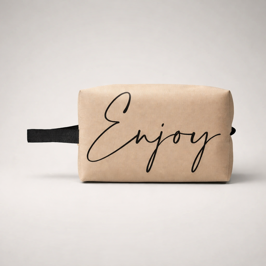 Beige canvas sports toilet bag mini with black cursive enjoy print and matching black strap for travel use