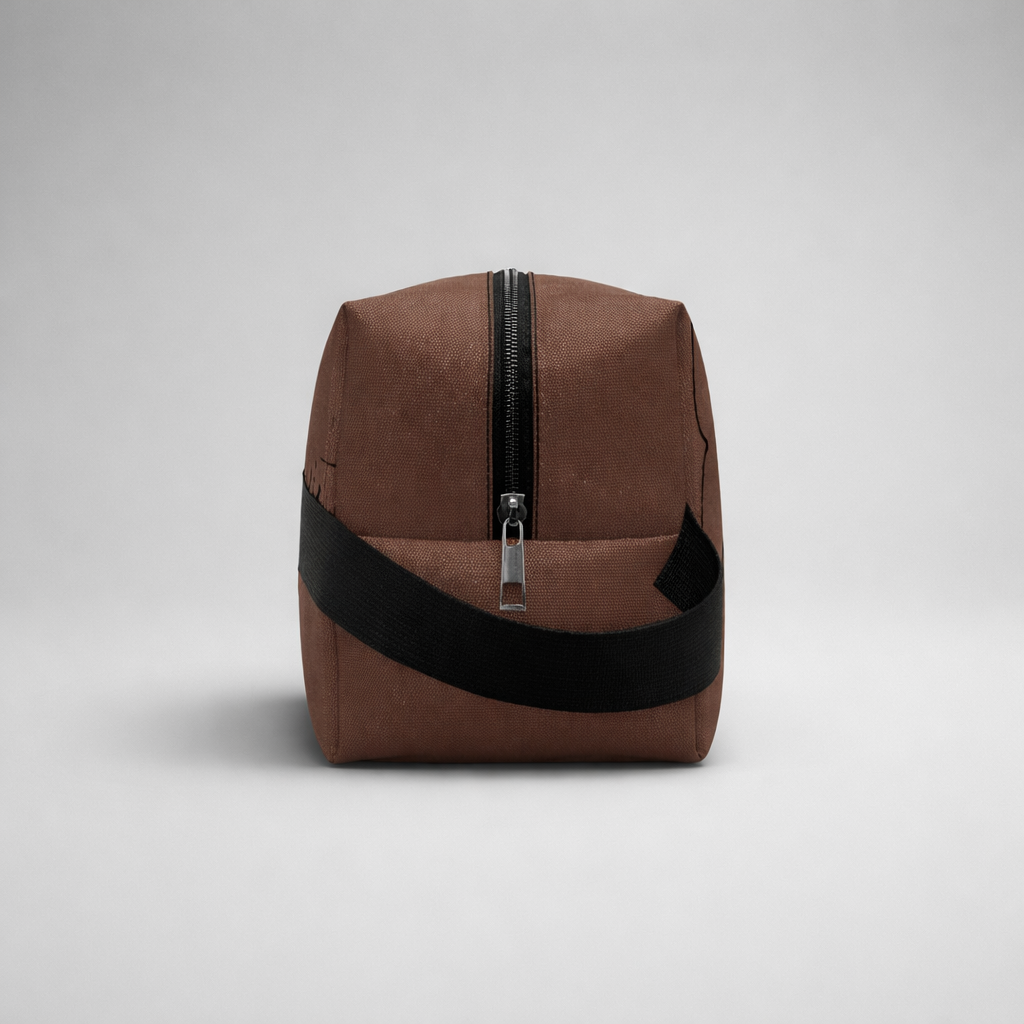 Brown canvas sports toilet bag mini with black zipper and matching strap for compact travel storage