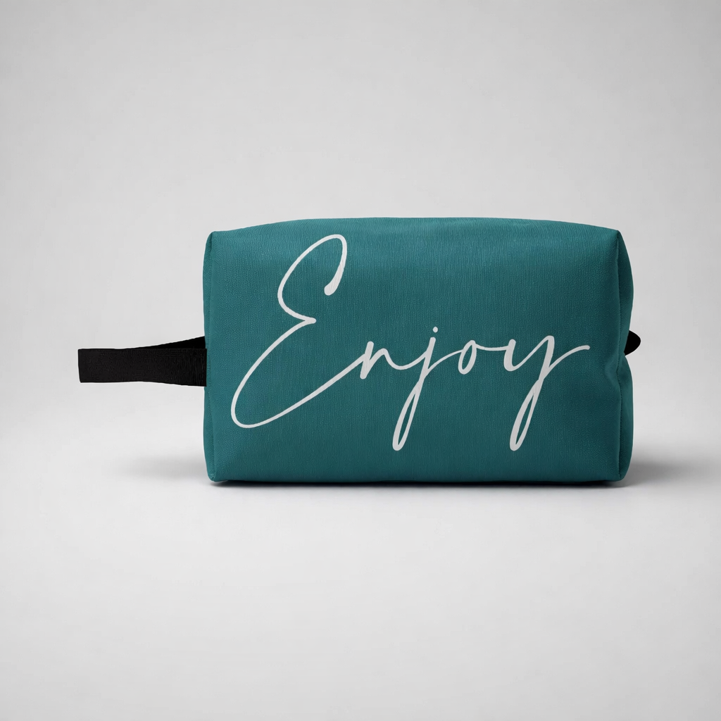 Mini sports toiletry bag in teal fabric with white enjoy lettering and a black handle for travel and gym use