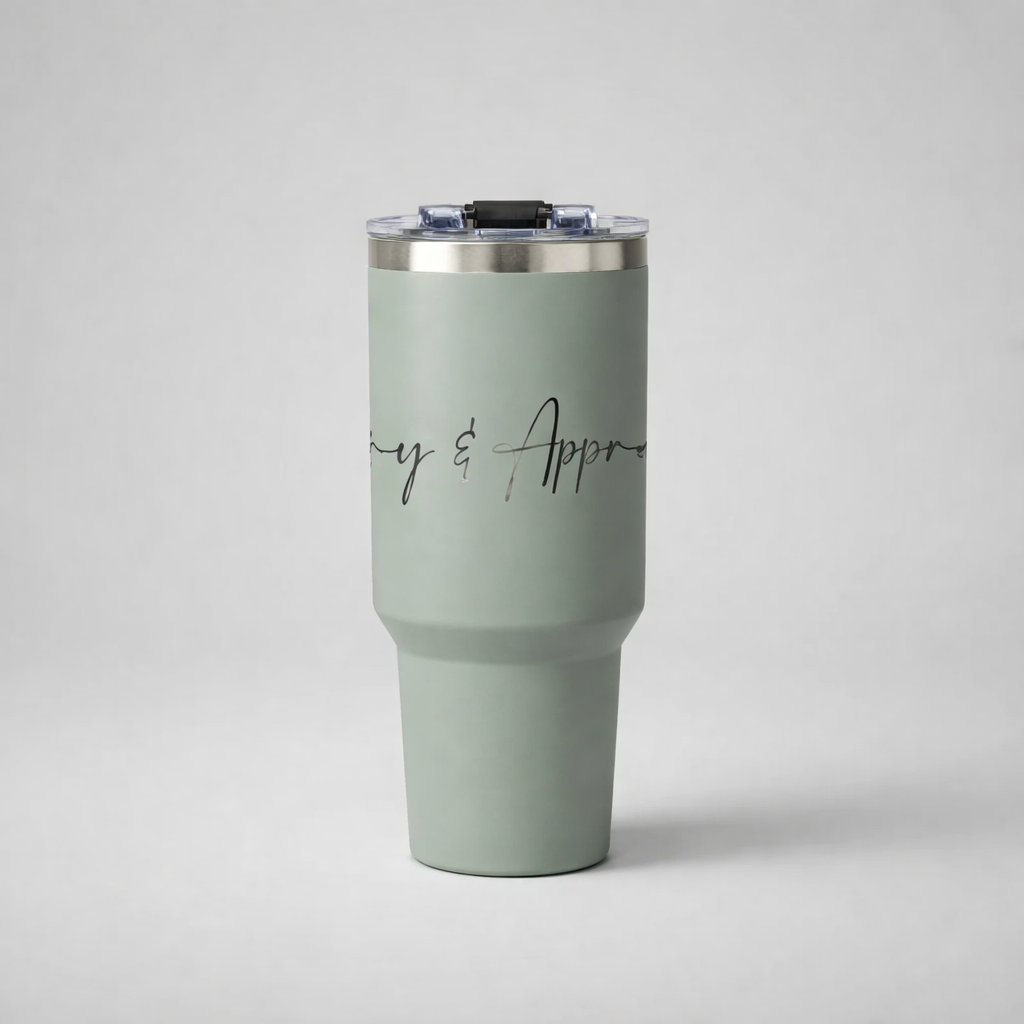 A matte sage green insulated sports mug with silver rim and clear lid featuring elegant black cursive lettering