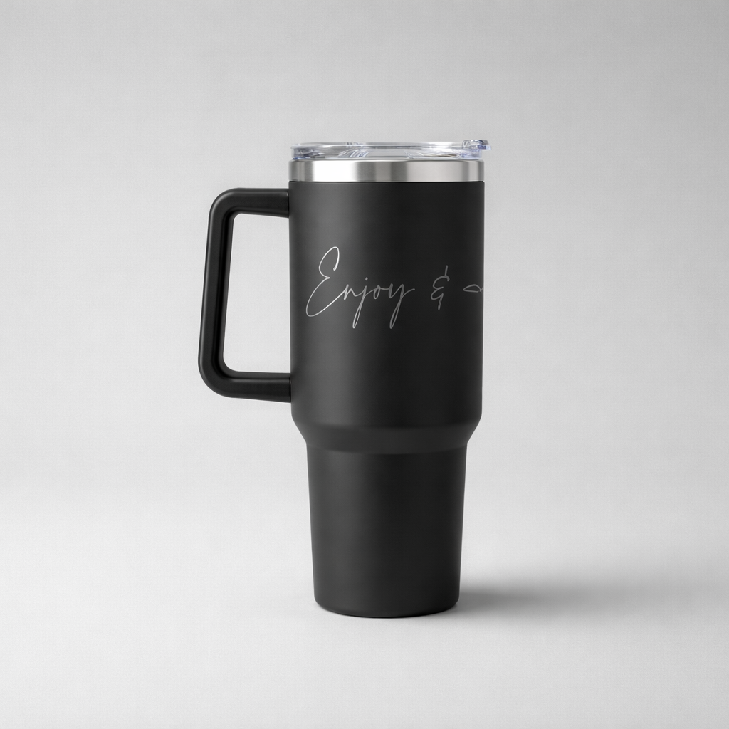 Black insulated sports mug with silver etched enjoy and script stainless steel lid and handle for travel use