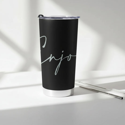 Black tumbler with 'Enjoy' text with a cleaning brush and metal straw on a light background