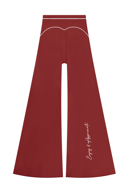 High Rise Flared Topstitching Pants in burgundy red with white contrast stitching and Enjoy & Appreciate script near the hem, by Lilliroa