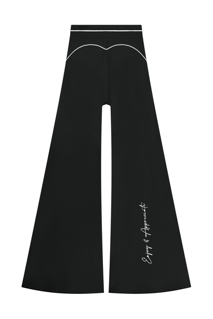 High Rise Flared Topstitching Pants in black with white contrast stitching, high waistband and Enjoy & Appreciate script on the lower leg, by Lilliroa
