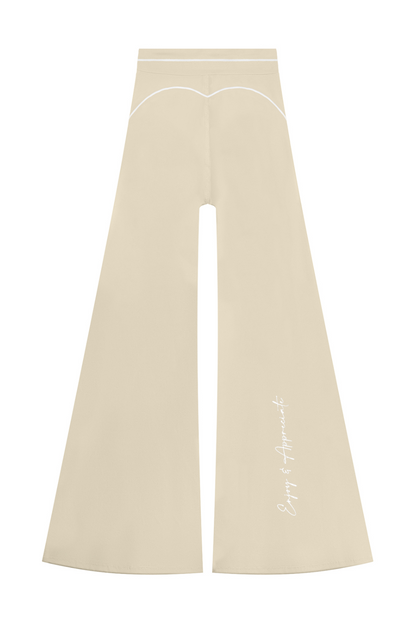 High Rise Flared Topstitching Pants in beige with white contrast stitching and Enjoy & Appreciate script on the lower leg, by Lilliroa