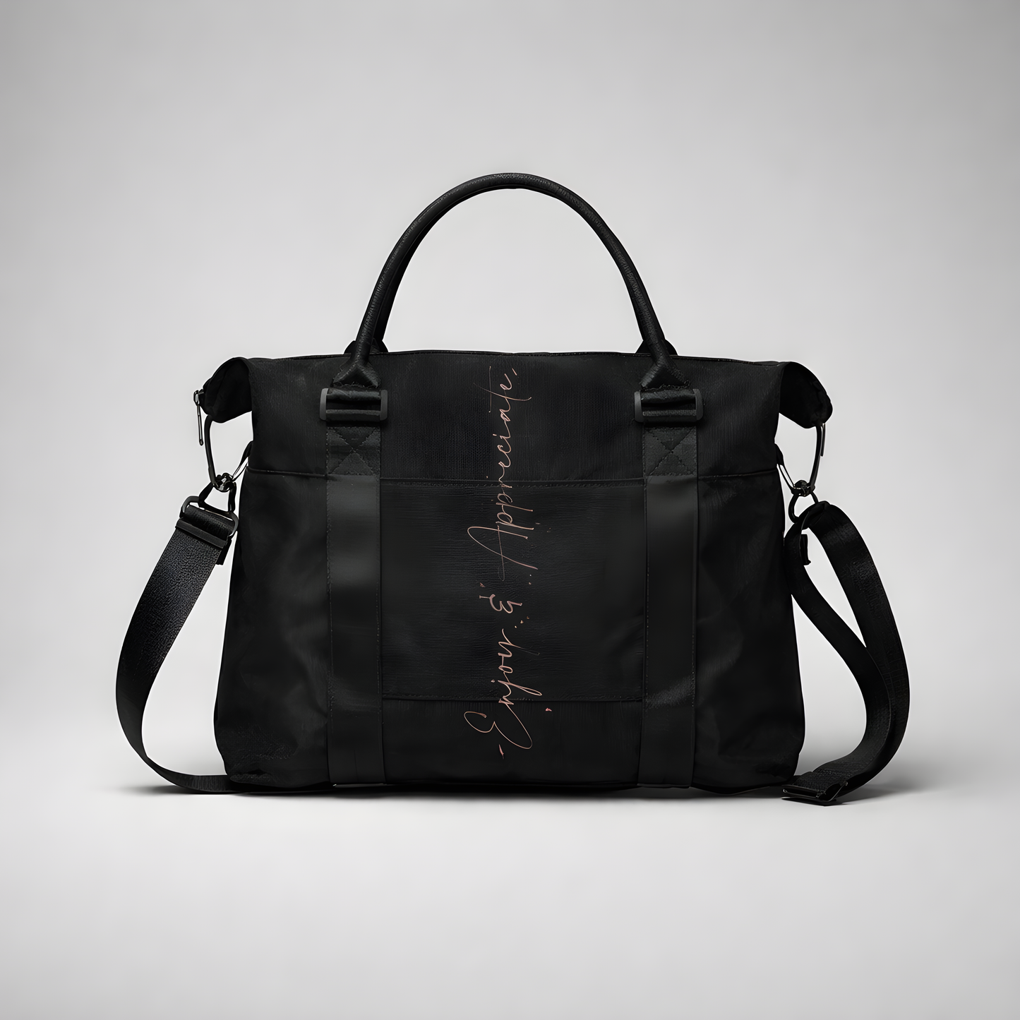 Black nylon travel bag with intention duffel featuring adjustable shoulder strap top handles and silver enjoy & appreciate script
