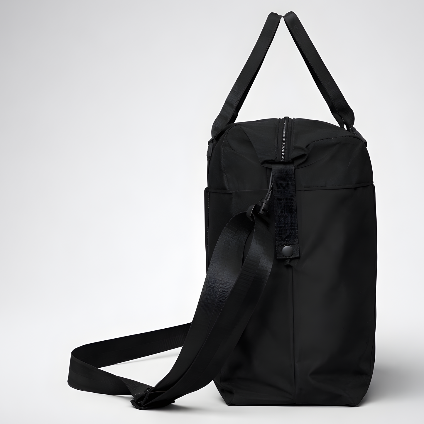 Black nylon travel bag with intention duffel bag featuring adjustable shoulder strap and top handles for easy carrying
