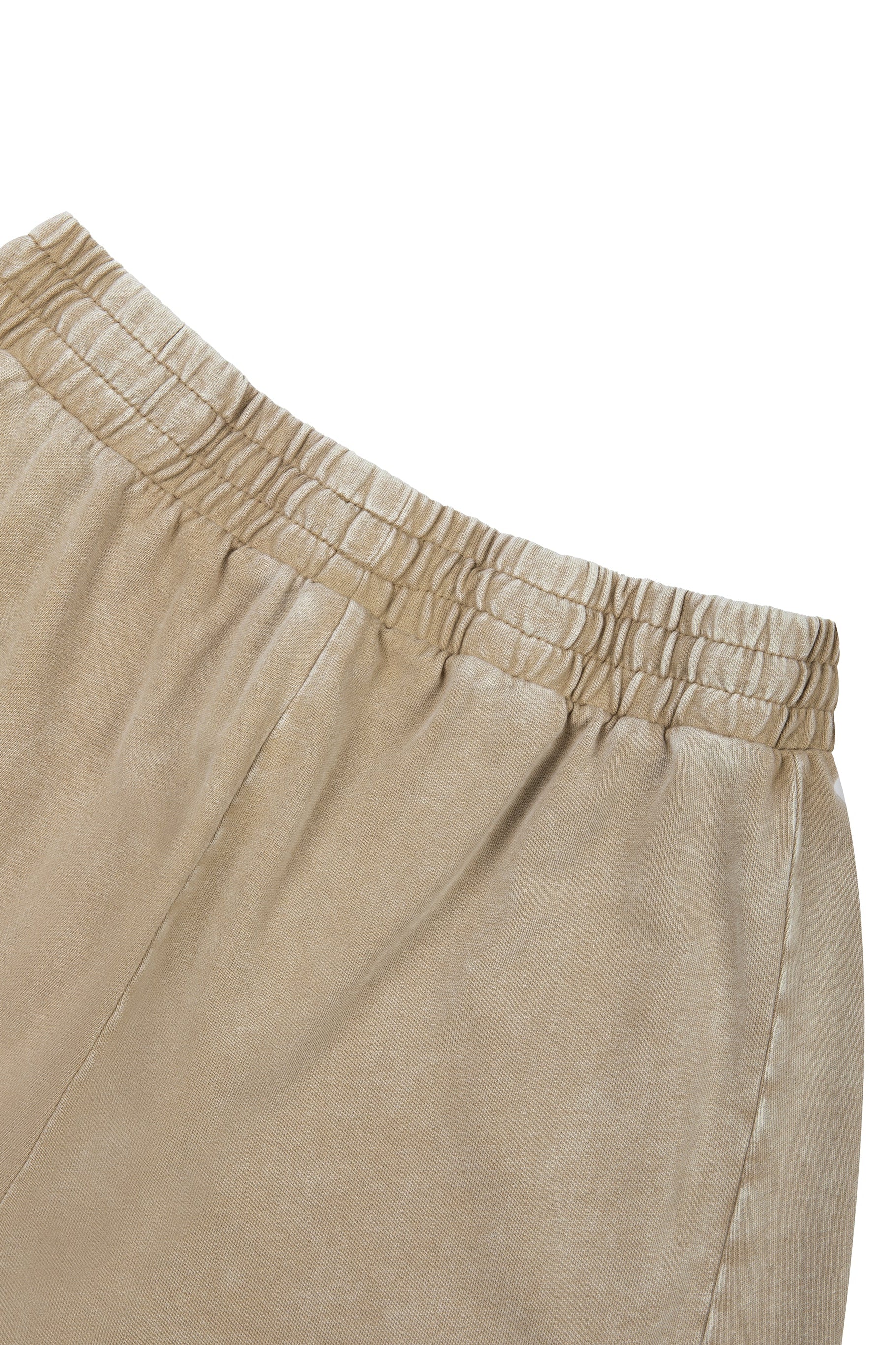 Close-up of beige pants with an elastic waistband on a white background