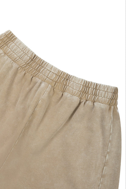 Close-up of beige pants with an elastic waistband on a white background