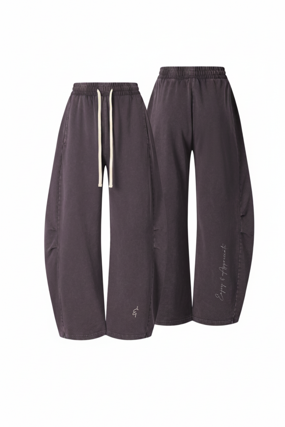 A pair of dark charcoal gray wide-leg sweatpants shown from two angles (front and side) against a plain white background. The front view shows an elastic waistband with white drawstrings, and the side view shows a slouchy leg with a small white script logo near the hem.