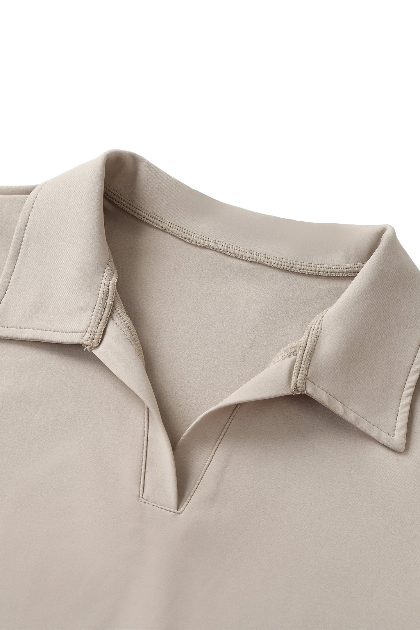 Close-up of a beige shirt collar on a white background