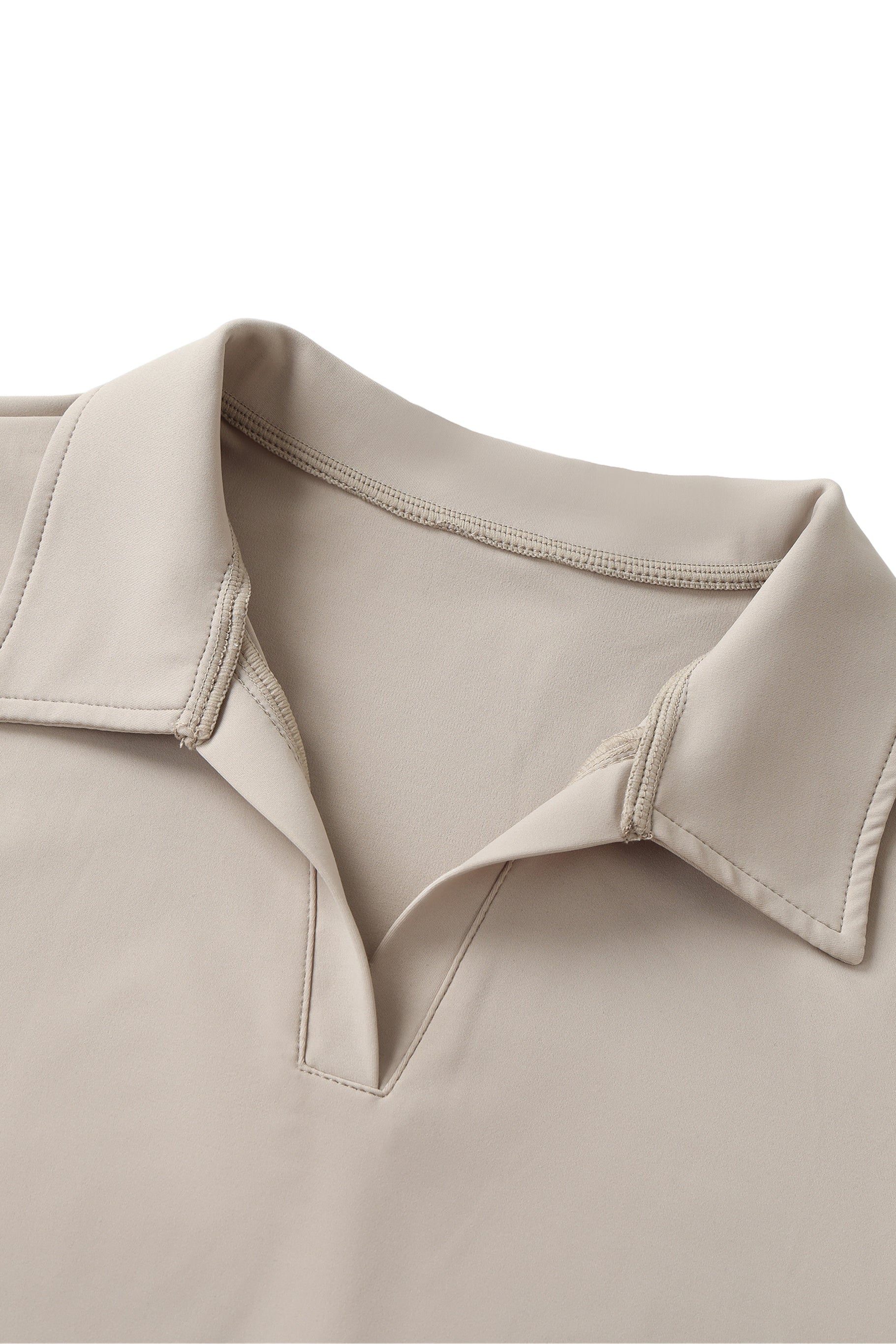 Close-up of a beige shirt collar on a white background