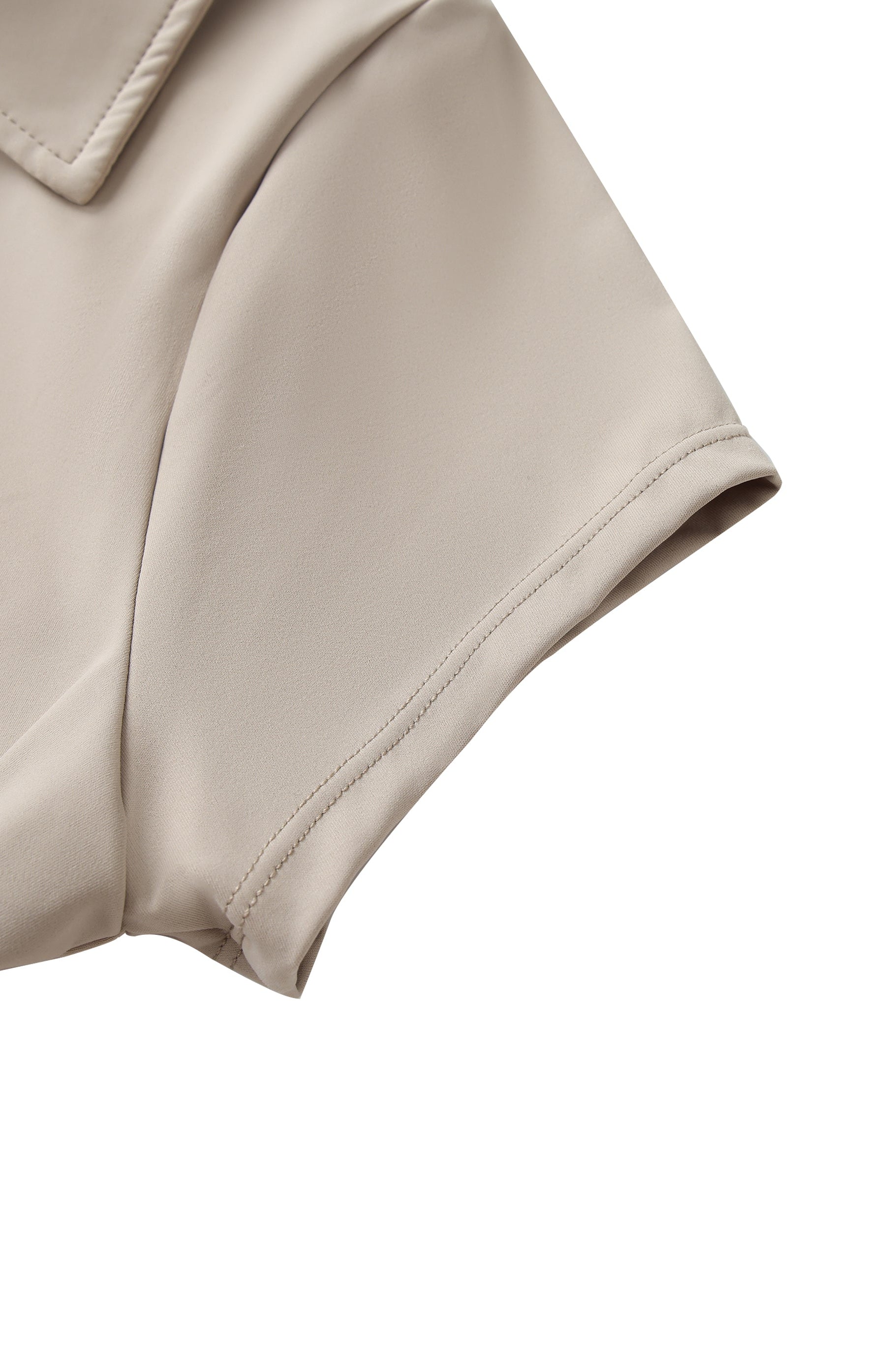Close-up of a beige leather jacket sleeve on a white background