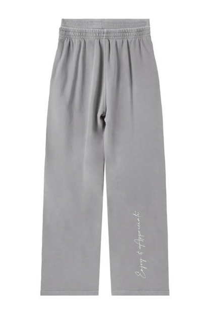Light gray wide-leg sweatpants with an elastic waistband and a small white script logo on the lower left leg, shown flat against a white background.