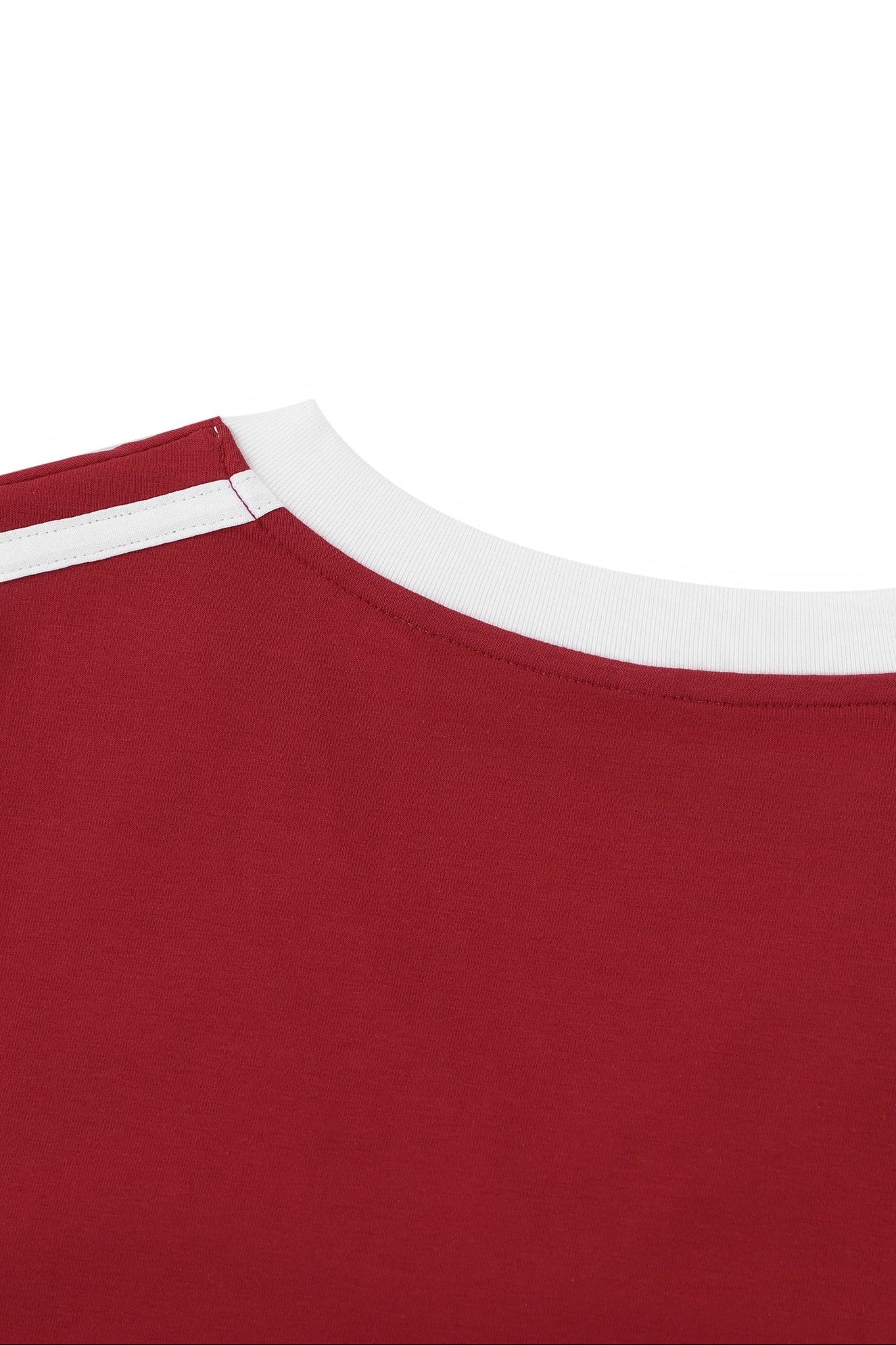 Close-up of a red shirt with white trim on a white background