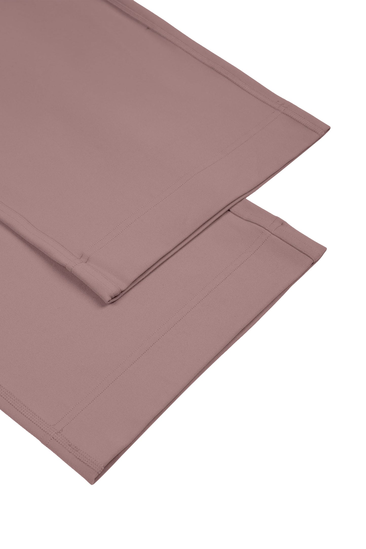 Folded mauve fabric on a white background