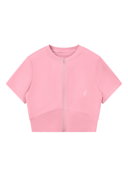 A light pink short-sleeve crop top with a full-length front zipper and a small white embroidered logo on the left chest, displayed on a solid white background.