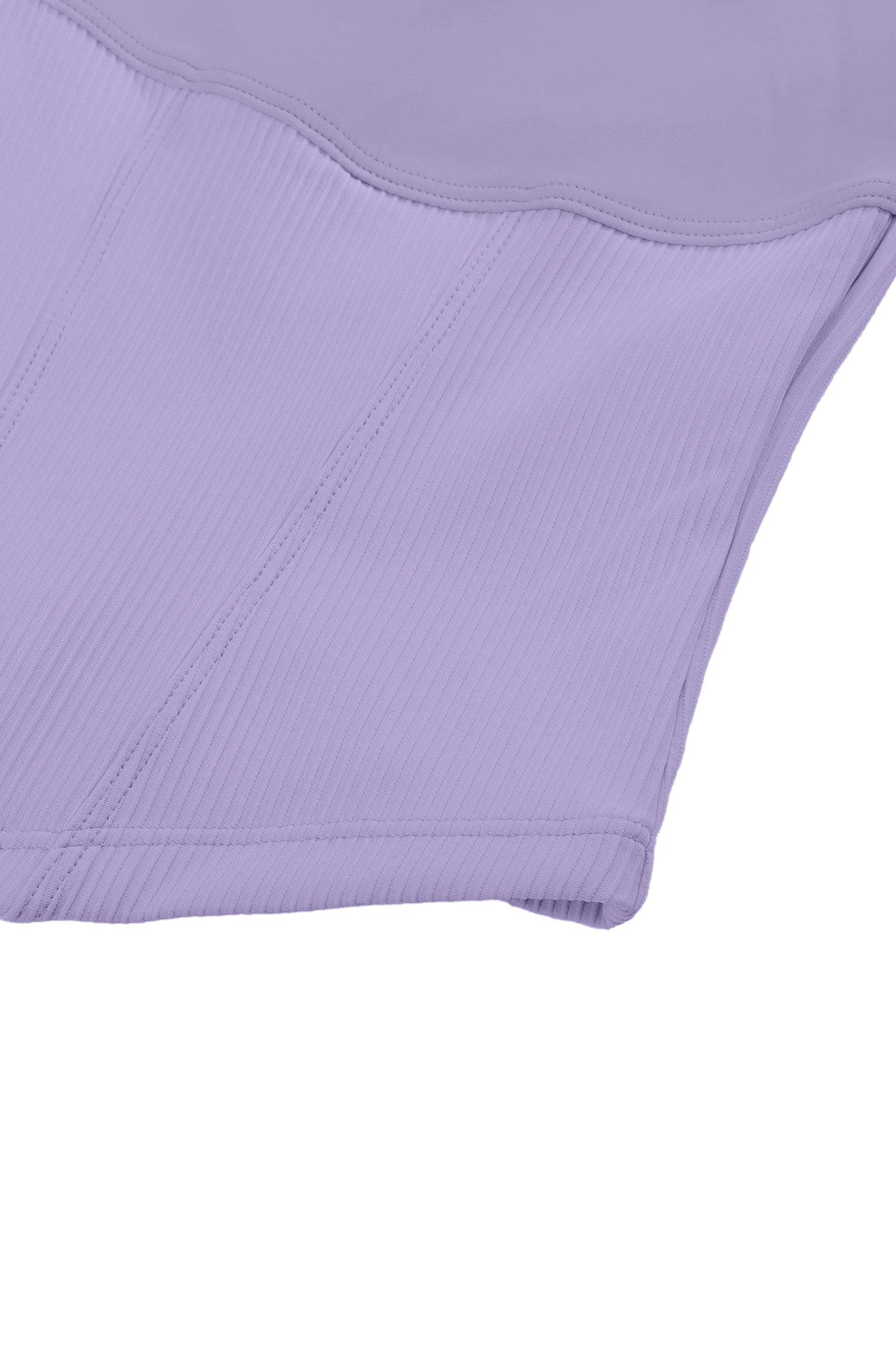 Close-up of a light purple garment with a textured pattern on a white background