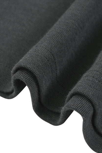 Close-up of a dark charcoal gray ribbed knit fabric, showing the texture and folded edges against a white background.
