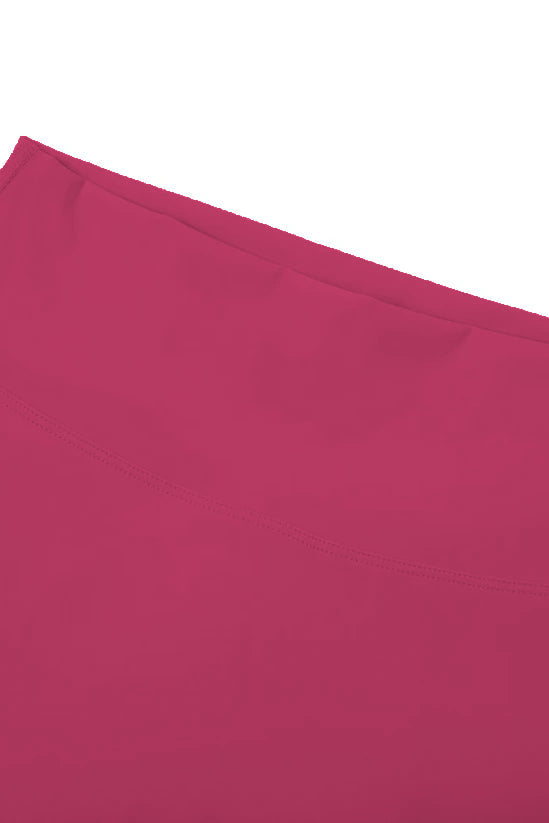 High-waisted seamless flared leggings in solid magenta fabric with smooth textured surface and neatly stitched hem