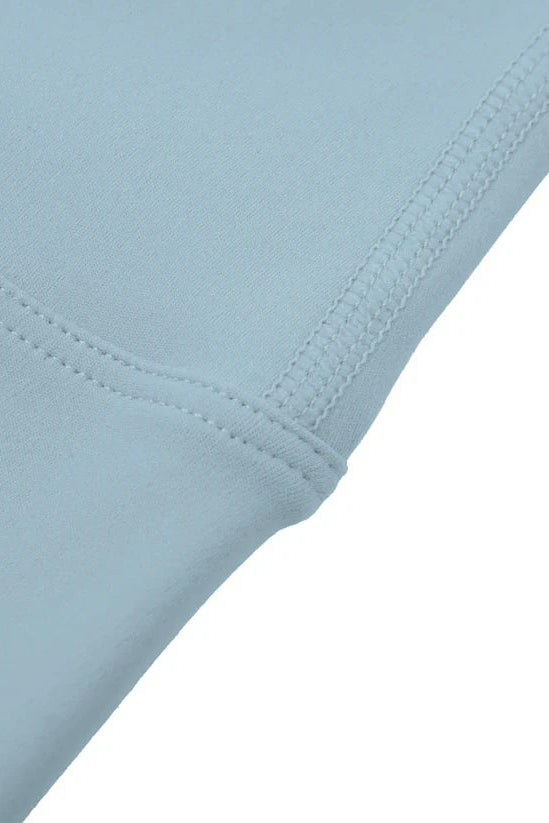 Close-up of light blue fabric with a white background
