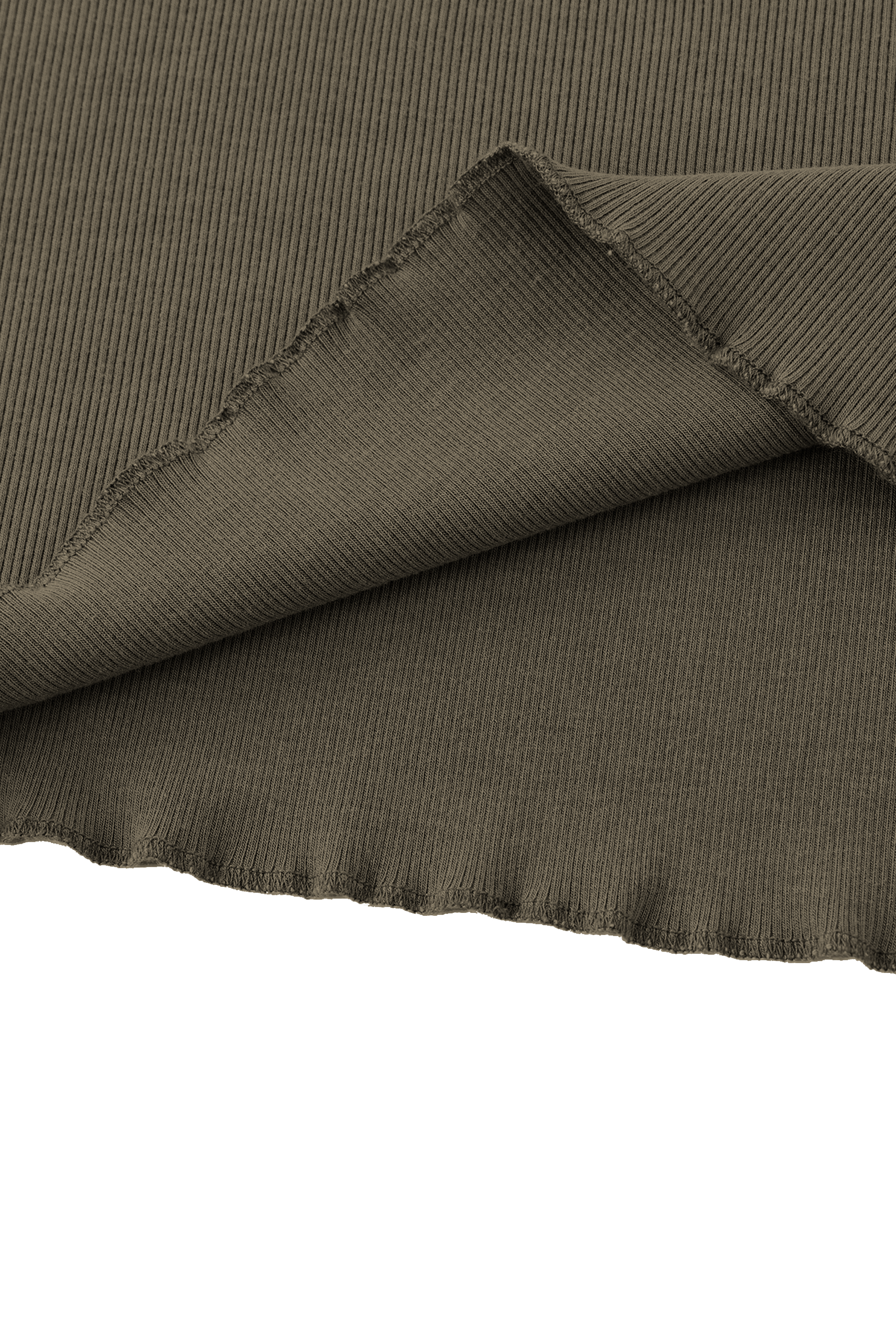 Close-up of the hem of a coffee coloured fabric with a textured pattern on a white background