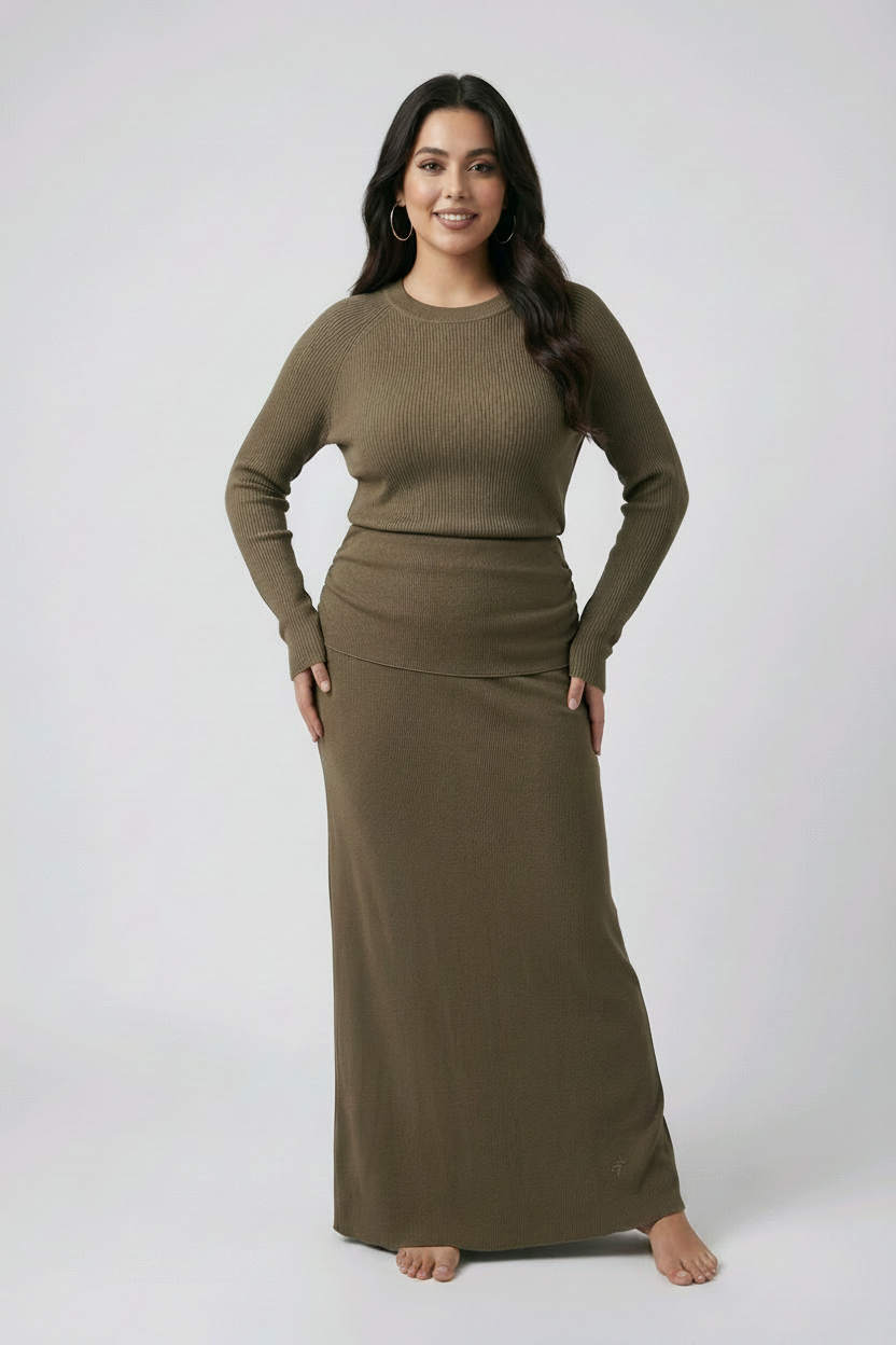 Woman wearing a coffee colour long-sleeve top and skirt set on a white background