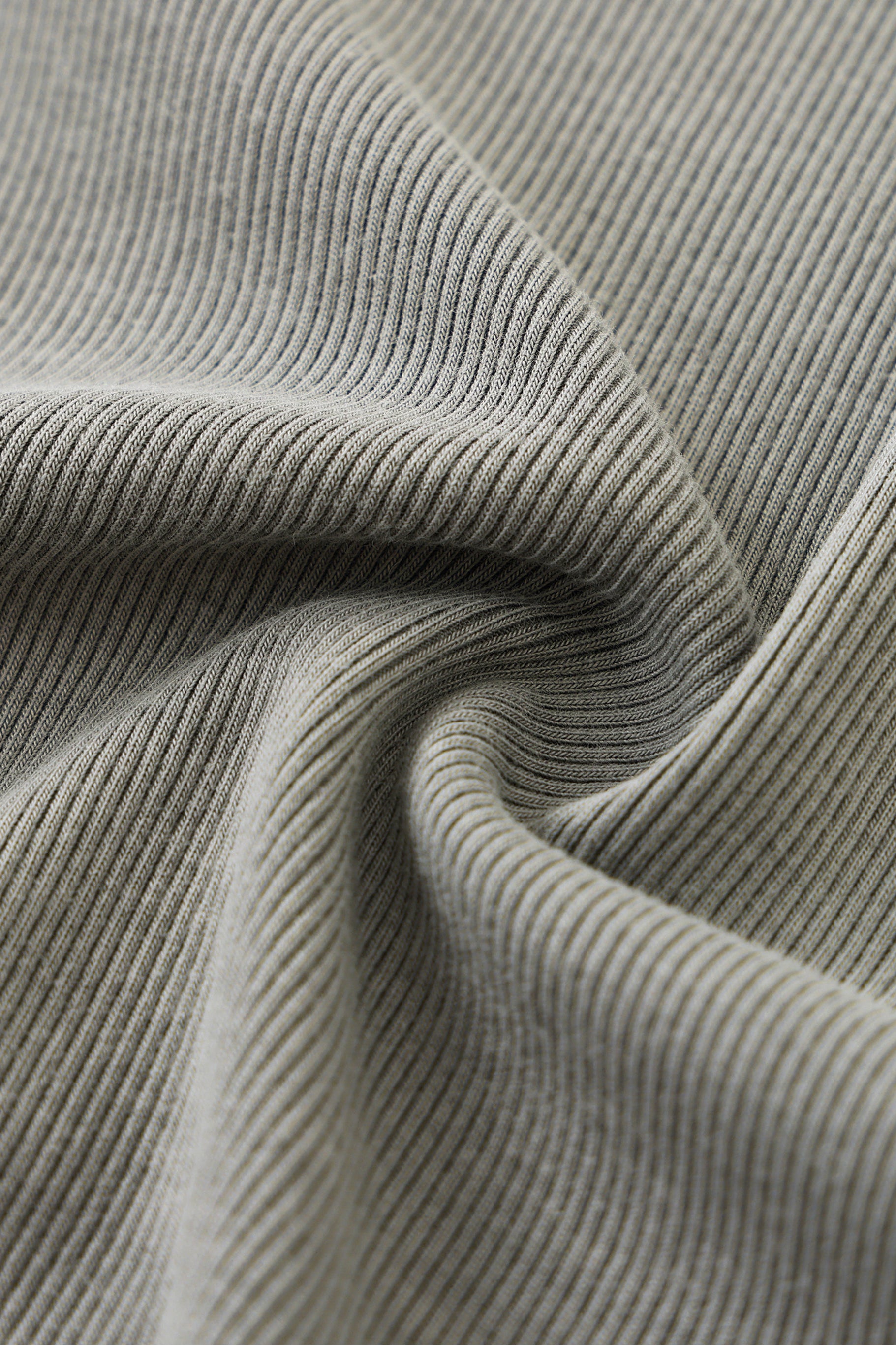 Close-up of gray ribbed fabric with folds